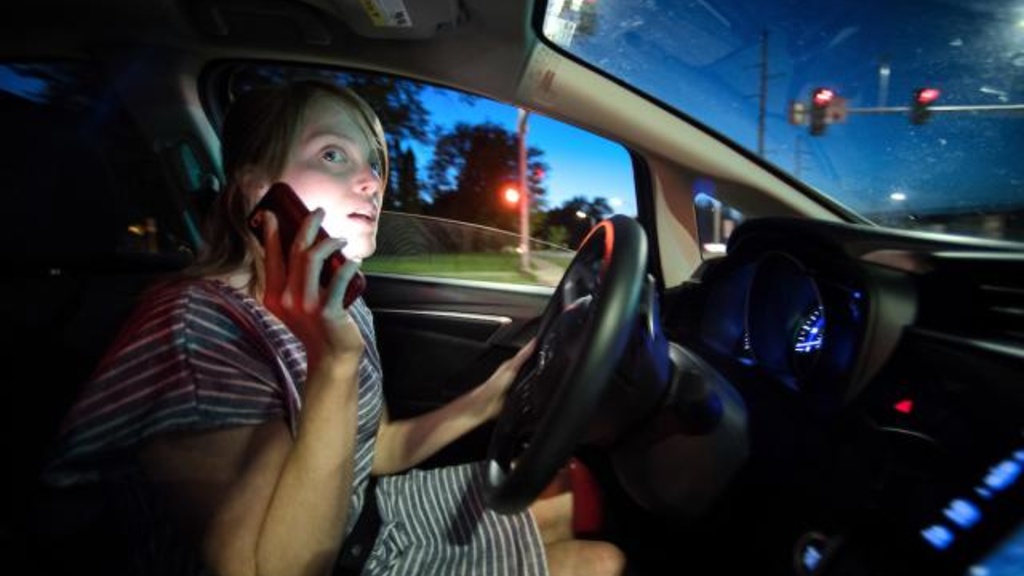 Woman driving while talking on the phone