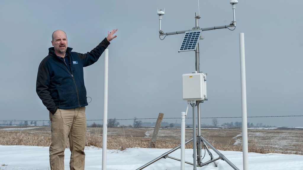 Man standing next to a solar panel