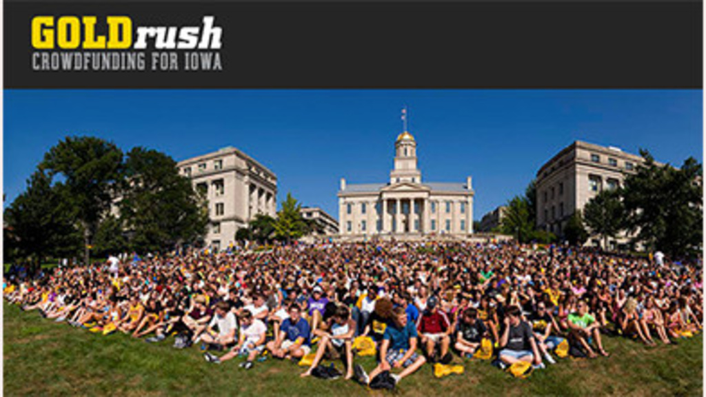 A large number of students sitting on the Pentacrest lawn in Iowa City