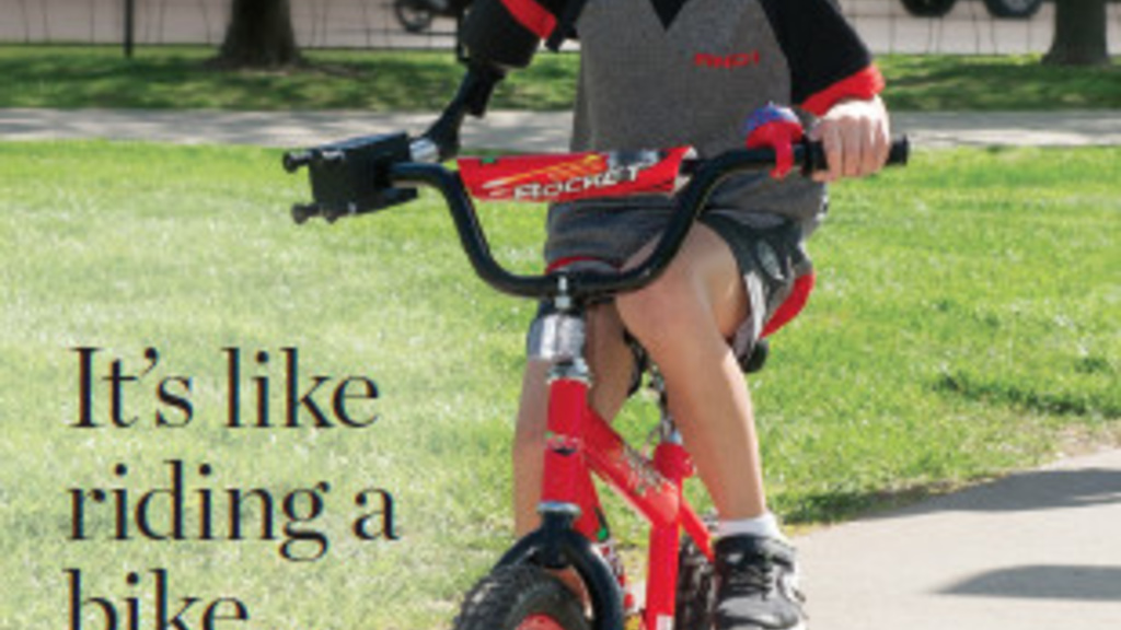 Iowa Engineer magazine cover, a boy riding a red bike