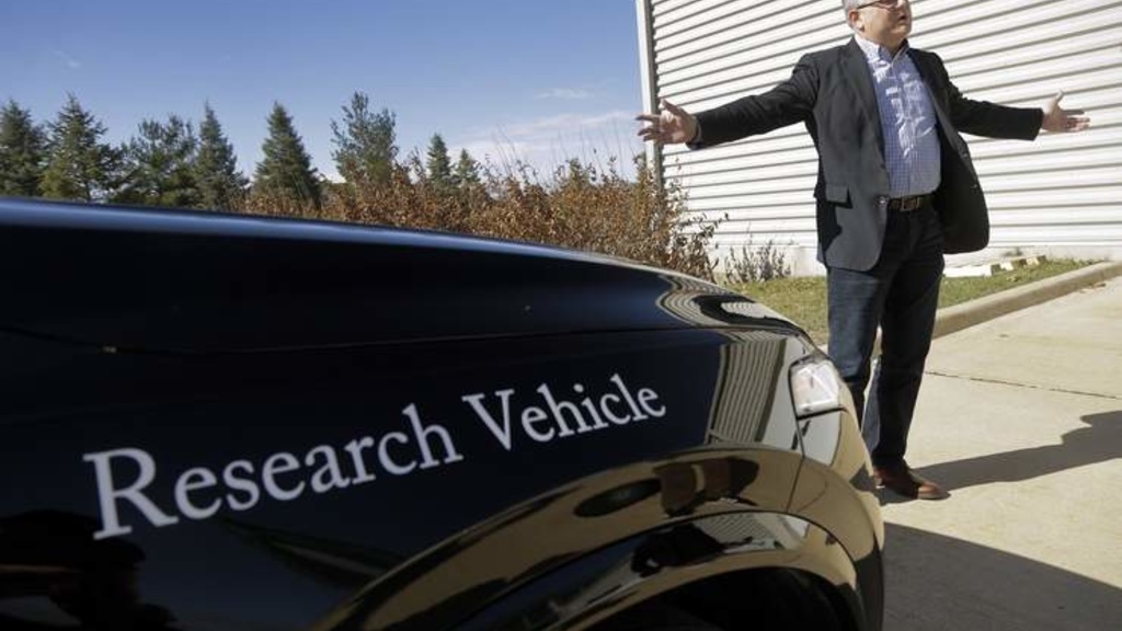 Man standing next to an autonomous vehicle