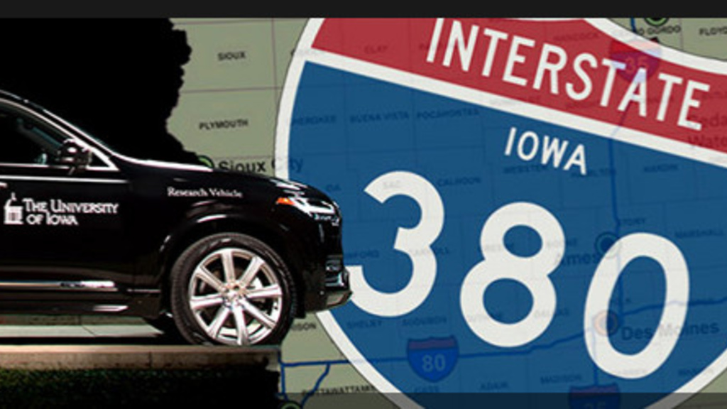 Photo of a car driving over a map of Iowa and an interstate 380 sign