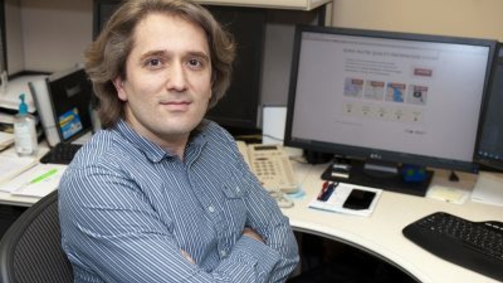 Photo of Ibrahim Demir sitting in front of a computer monitor