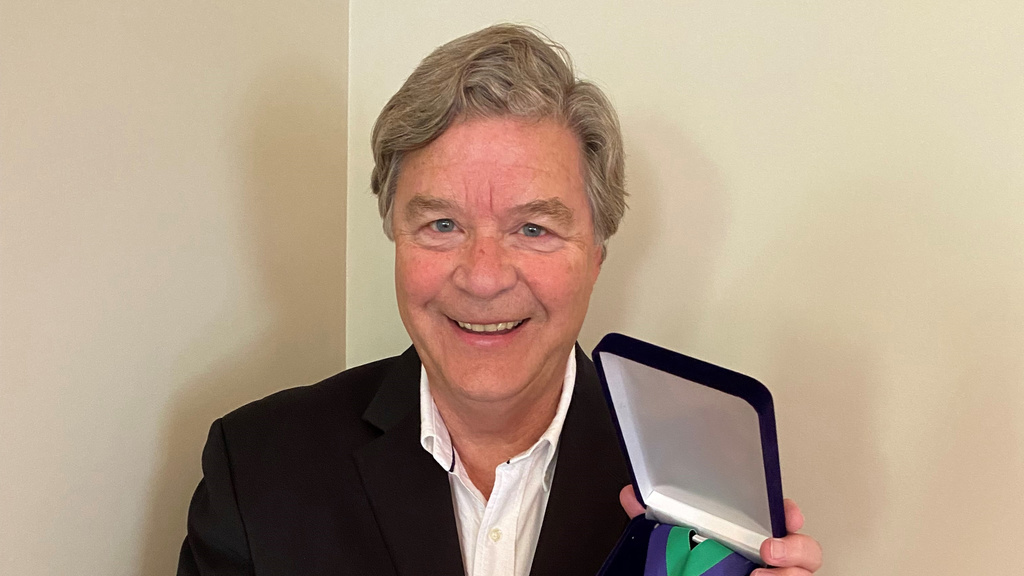 jerry schnoor holding medal