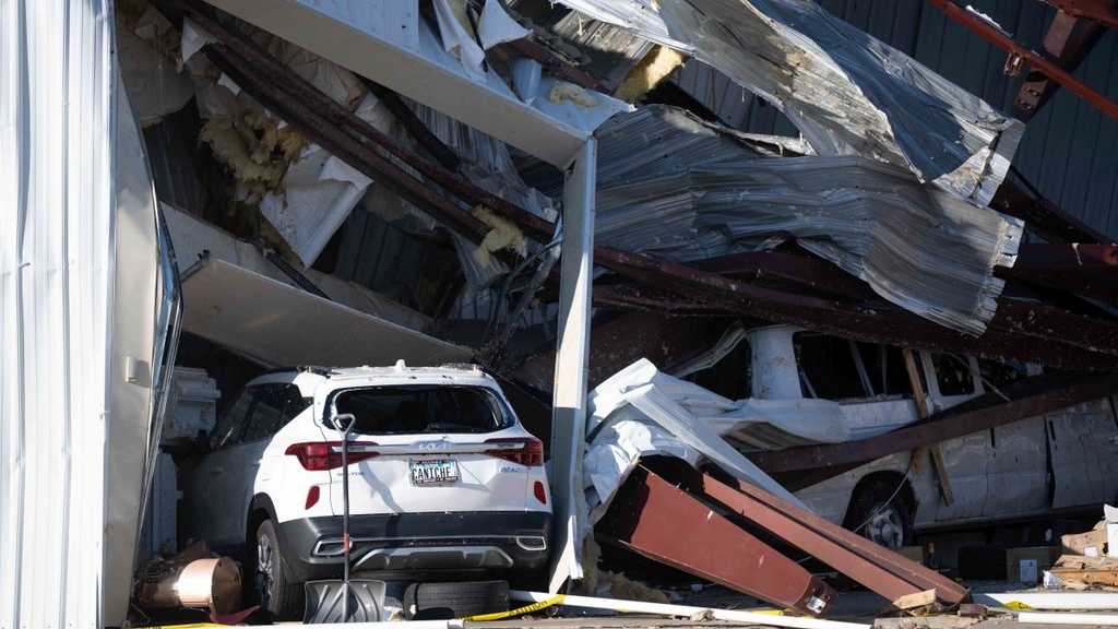 Damaged vehicles inside a damaged building