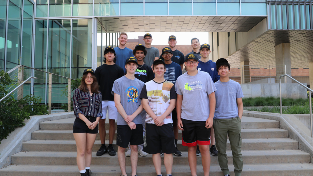 Students pose for a photo outside the Seamans Center