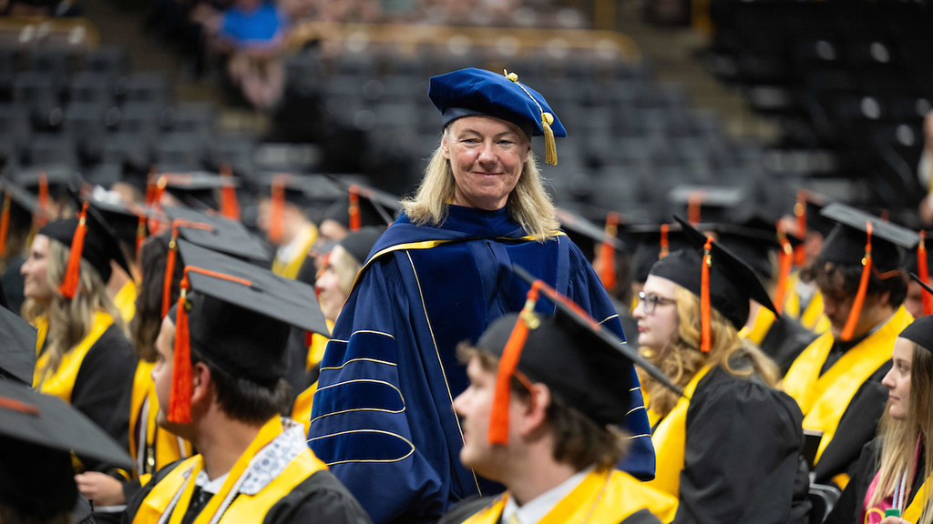 Dean Ann McKenna stands among students at commencement