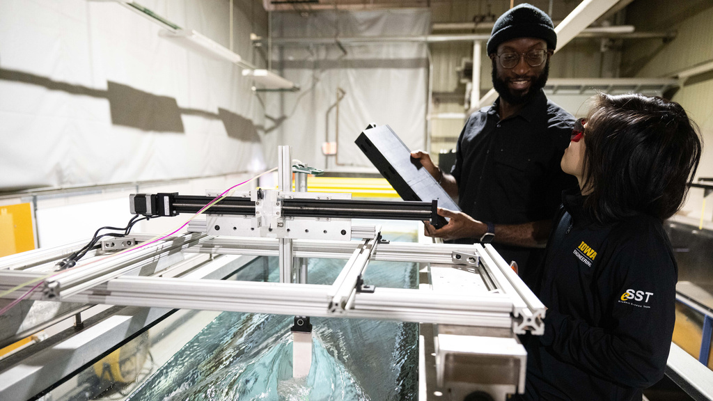 Two students work in a hydraulics lab