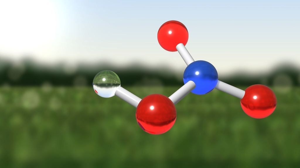 3D rendering of a nitric acid molecule (HNO₃) floating above a blurred green agricultural field. Red, blue, and white spheres represent oxygen, nitrogen, and hydrogen atoms connected by white bonds, with the molecular structure shown prominently in the foreground.
