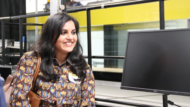 Visitor reviews equipment and displays in an engineering laboratory during a campus tour.