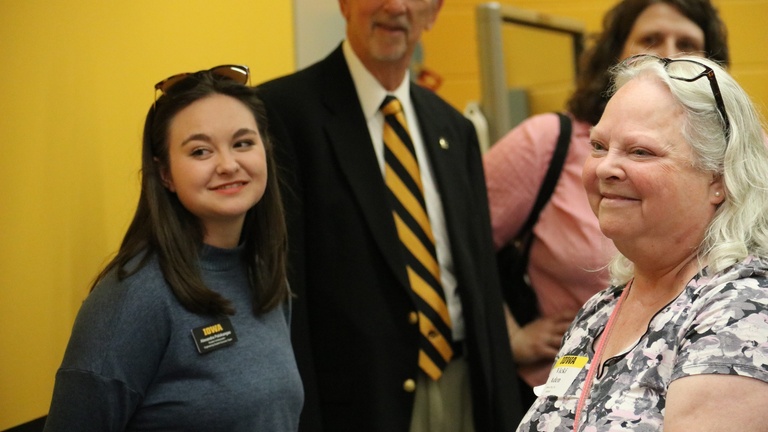 Alumni and guests observe a demonstration during a tour of an engineering facility.
